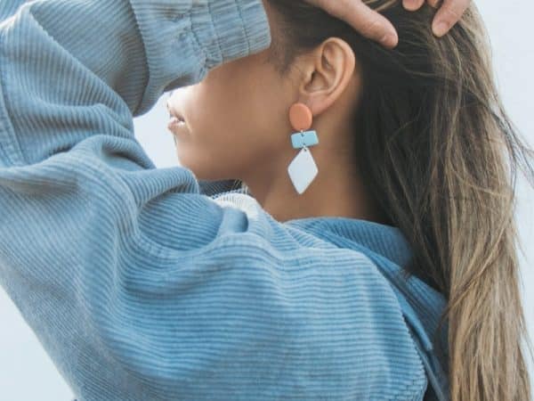 woman in blue sweater with white ribbon on her hair